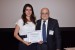 Dr. Nagib Callaos, General Chair, giving Prof. Renata Maria Abrantes Baracho the best paper award certificate of the session "Integrating Research, Education, and Problem Solving." The title of the awarded paper is "Information Management Processes for Extraction of Student Dropout Indicators in Courses in Distance Mode."